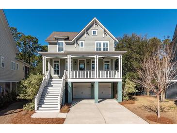 Two-story house with a front porch, two-car garage, and landscaping at 2084 Amenity Park Dr, Mount Pleasant, SC 29466