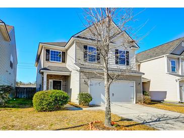 Two-story house with beige siding, black shutters, and a two-car garage at 234 Swamp Creek Ln, Moncks Corner, SC 29461