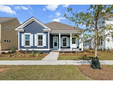 Charming craftsman style home with blue siding, light blue shutters, and a welcoming front porch at 349 Trailmore Ln, Summerville, SC 29486