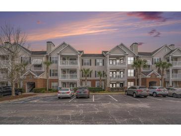 Three-story building with brick and siding, balconies, and ample parking at 45 Sycamore Ave # 523, Charleston, SC 29407