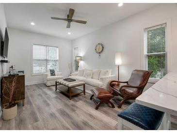 Bright living room features hardwood floors, comfy seating, and a stylish coffee table at 7311 Indigo Palms Way, Johns Island, SC 29455