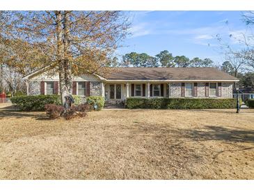 Charming single-story brick home featuring a covered front porch and well-maintained landscaping at 101 Winston Cir, Summerville, SC 29485