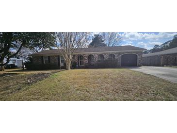 Charming brick home with a well-maintained front yard and attached garage at 102 Barrington Blvd, Goose Creek, SC 29445