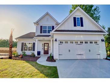 Charming two-story white home with an attached two-car garage and manicured landscaping at 108 Crosscut Ln, Summerville, SC 29486