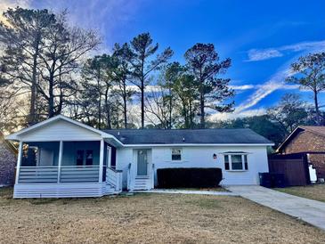 Charming single-story home featuring a screened-in porch and inviting curb appeal at 133 Larson Dr, Summerville, SC 29485