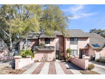 Charming townhome with brick-lined driveway and lush landscaping in a desirable neighborhood with mature trees at 313 Lapwing Ln, Mount Pleasant, SC 29464
