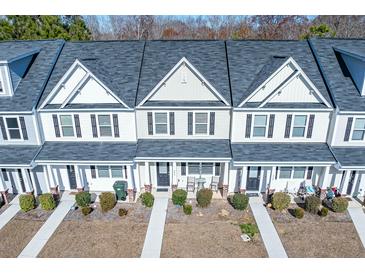 Charming townhomes featuring a symmetrical design, inviting entrances, and well-kept lawns at 393 Flyway Rd, Goose Creek, SC 29445
