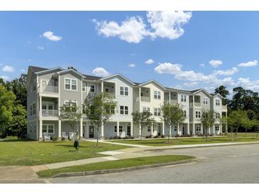 Charming apartment building with colorful siding, well-kept lawns, and inviting walkways on a sunny day at 637 N Laurel St # 75, Summerville, SC 29483