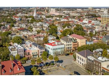 Stunning aerial view showcases Charleston's colorful architecture, lush trees, and charming streetscapes in a vibrant urban setting at 71 E Bay St, Charleston, SC 29401
