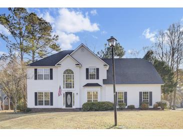Two story white house with black shutters, a large front yard, and a lamp post at 7897 Sabalridge Dr, North Charleston, SC 29418