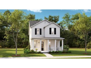 Charming two-story white home featuring a welcoming front porch and beautifully landscaped yard at 144 Maritime Way, Summerville, SC 29485