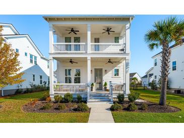 Charming two-story white home featuring double porches, manicured landscaping, and a welcoming entrance at 1714 Banning St, Mount Pleasant, SC 29466