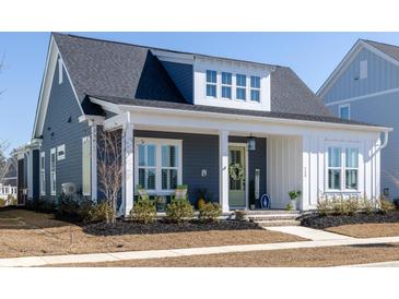 Charming home featuring a welcoming front porch, stylish decor, and meticulously landscaped front yard at 332 Clearpath Dr, Summerville, SC 29486
