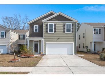 Charming two-story home featuring a two-car garage and neutral siding at 9747 Roseberry Street, Ladson, SC 29456