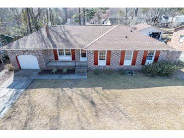 Charming brick home featuring red shutters, well-maintained landscaping, and a spacious front yard at 106 Rachel St, Goose Creek, SC 29445