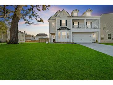 Charming two-story home with landscaped yard, a two-car garage and a lovely second story porch at 1105 Mossy Rock Dr, Summerville, SC 29485