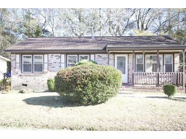 Cozy brick home with manicured front lawn and mature shrubbery at 1927 Hazelwood Dr, Charleston, SC 29407