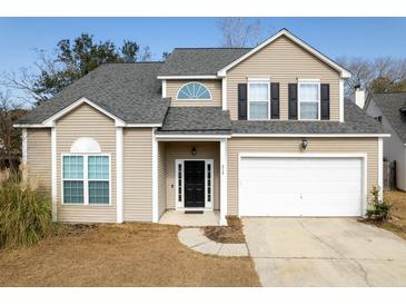 Charming two-story home featuring a two-car garage, black door, and neutral-toned siding at 215 Evesham Dr, Summerville, SC 29485