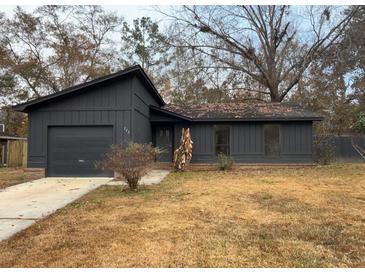Charming single-story home featuring a dark exterior, attached garage, and well-manicured lawn at 222 Braly Dr, Summerville, SC 29485
