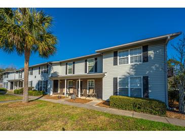 Multi-Gathering home featuring neutral siding, black shutters, covered porch, and manicured landscaping at 2494 Etiwan Ave # B-4, Charleston, SC 29414