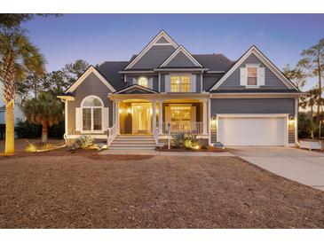 Charming two-story gray home featuring manicured landscaping, inviting front porch, and attached two-car garage at 3004 Riverwood Dr, Mount Pleasant, SC 29466