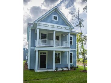 Charming two-story home with light blue siding, white trim and a cozy second story balcony at 306 O'Malley Dr, Summerville, SC 29483