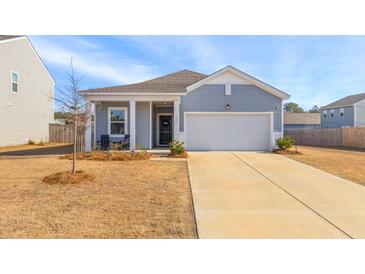 Charming single-story home with a welcoming front porch and well-manicured lawn at 454 Pender Woods Dr, Summerville, SC 29486