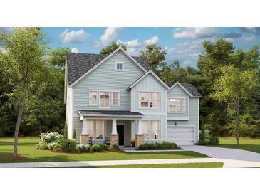 Charming two-story home with light blue siding, a covered porch, and an attached garage at 105 Pen Shell St, Summerville, SC 29485