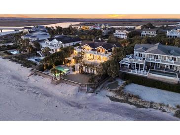 A stunning beachfront home with private pool, multiple balconies, and panoramic ocean views at sunset at 112 Ocean Blvd, Isle of Palms, SC 29451