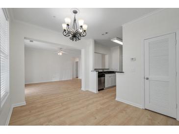 Bright living space with chandelier, open floorplan, and stainless-steel kitchen appliances at 130 River Landing Dr # 5108, Charleston, SC 29492