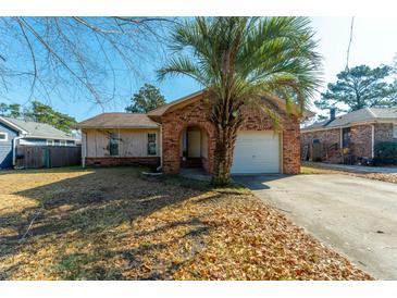 Charming brick home with a well-maintained front yard and mature trees at 204 E Edgefield Dr, Summerville, SC 29483