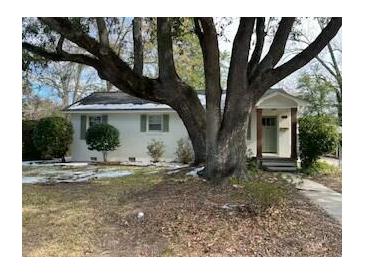Charming single-story home with a beautifully landscaped front yard and mature trees at 5110 Temple St, North Charleston, SC 29405
