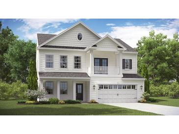 Stunning two-story white home featuring a balcony, a two-car garage and lush green landscaping at 203 Pine Crest View Dr, Summerville, SC 29486