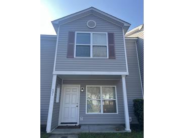 Charming two-story home showcasing a welcoming front door and neutral siding at 531 Travelers Blvd, Summerville, SC 29485