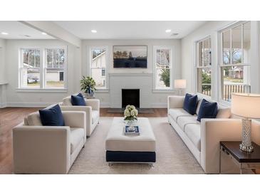 Bright living room featuring a fireplace, hardwood floors, and plenty of natural light at 1226 Pickens St, Hanahan, SC 29410