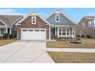 Charming single-Gathering home featuring a stone facade, two-car garage, and covered front porch at 2006 Barn Swallow Rd, Summerville, SC 29483