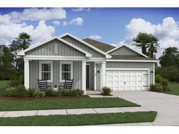 Charming home with a two-car garage, inviting porch, and well-manicured lawn at 2018 Mcguire Ln # 005, Hollywood, SC 29449