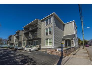 A view of the building showcasing its multi-story design and exterior architecture under a clear blue sky at 259 E Bay St # 1 C, Charleston, SC 29401