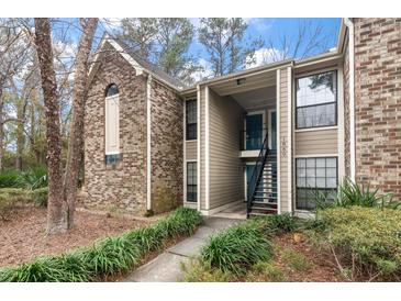 Charming condo building featuring brick and siding exterior with landscaped grounds and visible unit number at 1860 Montclair Dr # 1860-A, Mount Pleasant, SC 29464