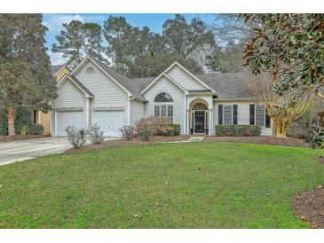 Charming single-story home featuring a two-car garage, a well-maintained lawn, and classic curb appeal at 2005 Carriage Way, Summerville, SC 29485