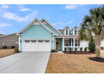Charming home featuring a three-car garage, dormer windows, teal siding, and a well-manicured front yard at 3115 Cross Vine Ln, Summerville, SC 29483