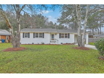 Charming white brick home with a lush front lawn and classic black shutters at 337 Cessna Ave, Charleston, SC 29407