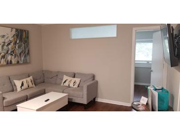 Inviting living room featuring a comfortable gray sectional and stylish decor at 40 Bee St # 309, Charleston, SC 29403