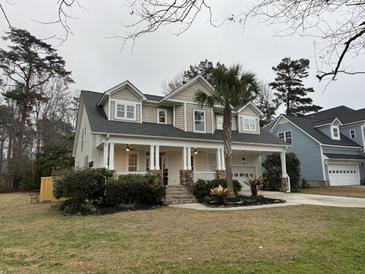 Charming two-story home with a spacious front porch and landscaped yard at 130 Marshside Dr, Summerville, SC 29485