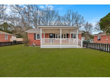 Charming red brick home with a inviting front porch and a well-manicured green lawn at 312 Mary Scott Dr, Goose Creek, SC 29445