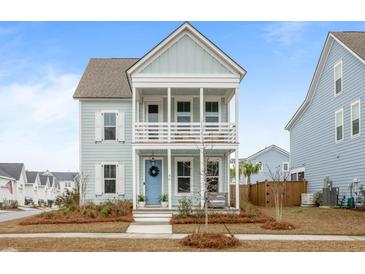 Charming two-story home with double porches, a blue front door, and meticulously landscaped yard at 46 Clearblue Loop, Summerville, SC 29486