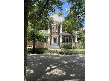 Charming two-story brick home with inviting porch and manicured landscaping at 56 Laurens St, Charleston, SC 29401