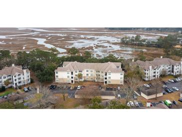A vibrant aerial view shows the condo's stunning waterfront location and well-maintained exteriors at 700 Daniel Ellis Dr # 8304, Charleston, SC 29412