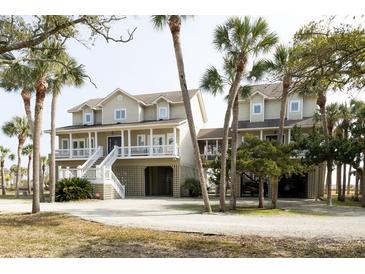 Charming two-story coastal home featuring a spacious porch and beautiful architectural details at 10 Toms Turnaround Cir, Edisto Island, SC 29438