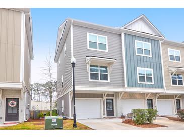 Charming two-story townhome with attached one car garage and colorful exterior design at 1241 Allusion Ln, Mount Pleasant, SC 29466